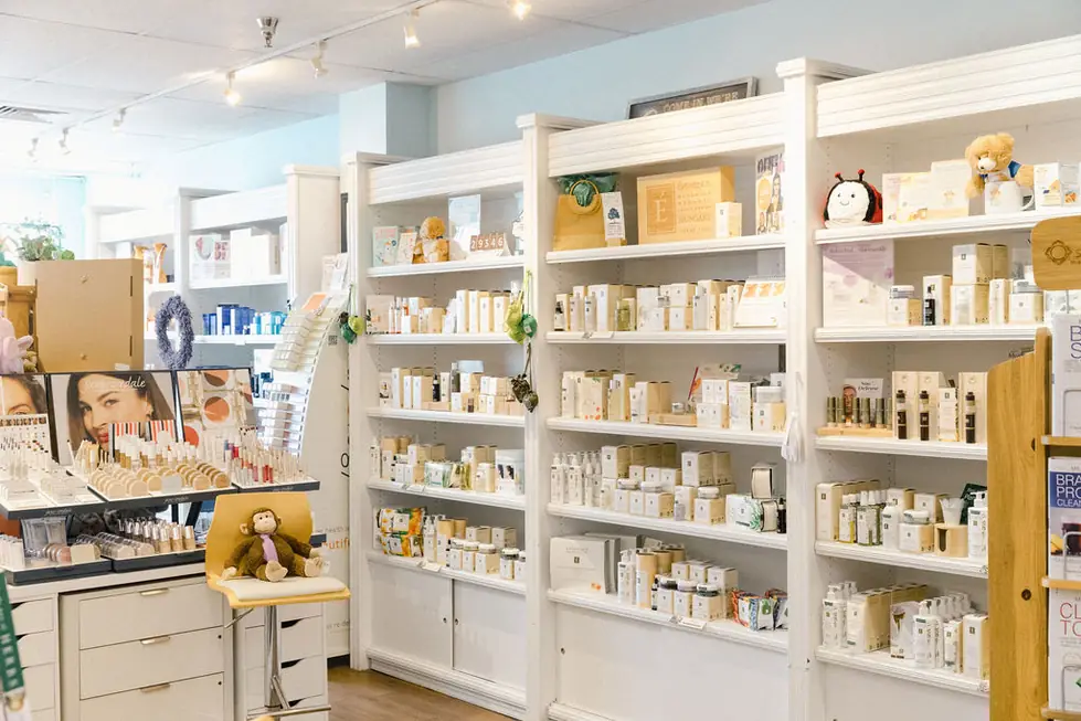 The apothecary wall of Eminence Organic Skin Care on white shelving